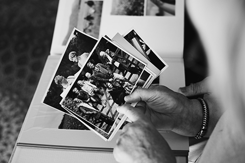 Senior couple looking at family photo album