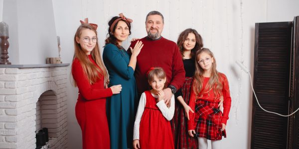 Big family in a room. Mother with four daughter.